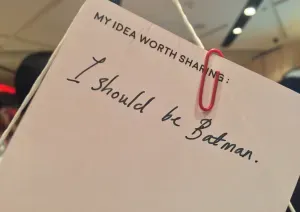A card that reads “I should be Batman”