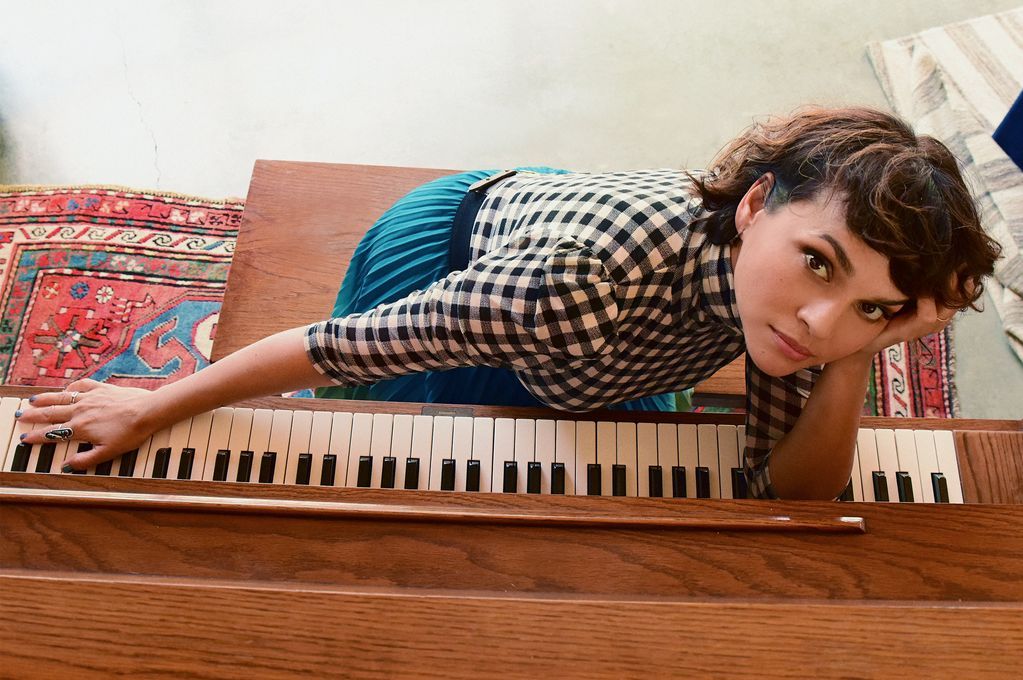 Promotional poster of the tour showing Norah with a piano
