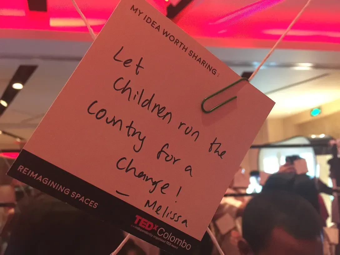A card that reads “let children run the country for a change”