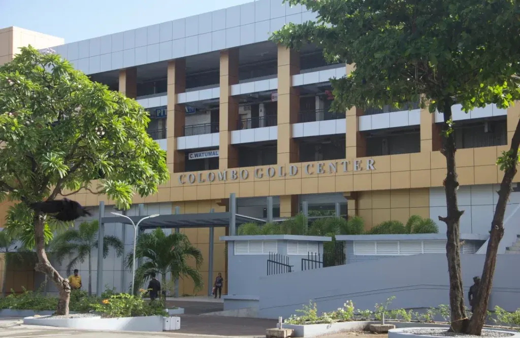 A view of the Colombo Gold Centre building through the trees
