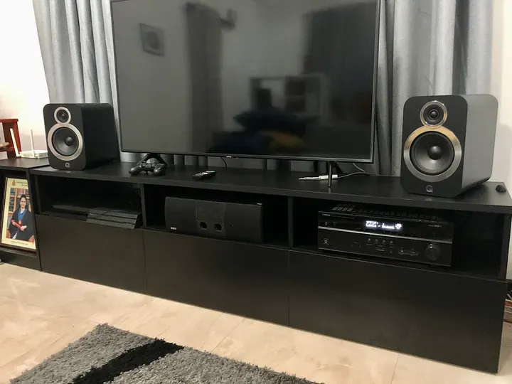 My speaker setup, with a my TV in the middle and amp/receiver in a shelf beneath it