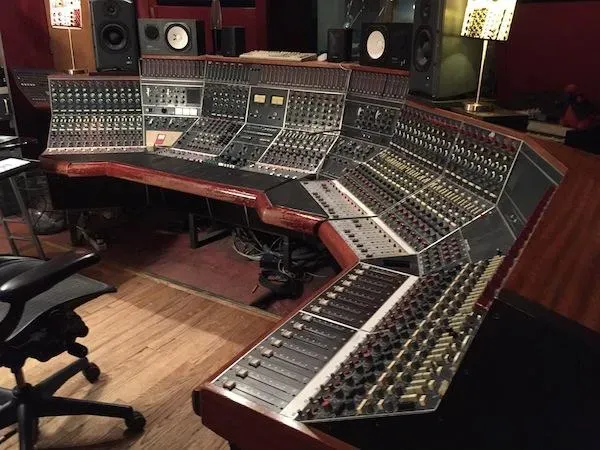 A large studio console table with many switches, dials and doodads I don’t know the names of
