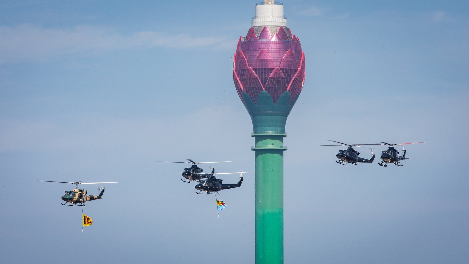 Helicopters doing a flyby at the Sri Lankan Independence Day Parade. The Lotus Tower can be seen in the background.