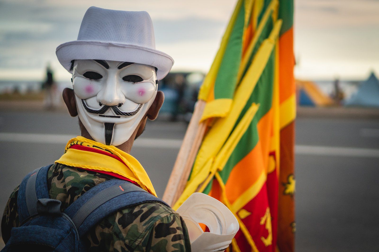 A vendor at Galle Face Green selling Guy Fawkes masks and Sri Lankan flags