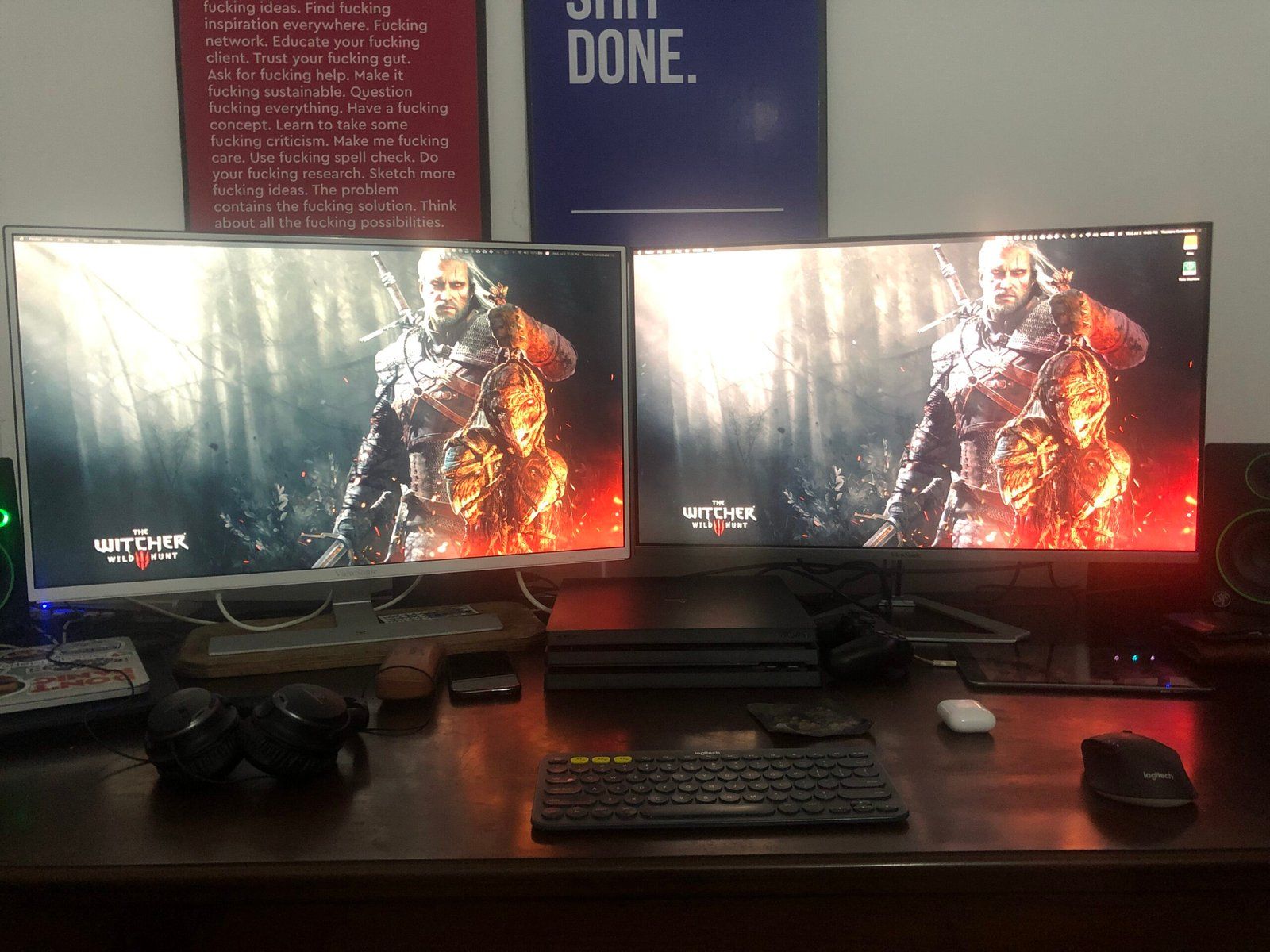 Desk setup featuring two monitors, on which a Wallpaper of Geralt of Rivia from The Witcher 3 is displayed