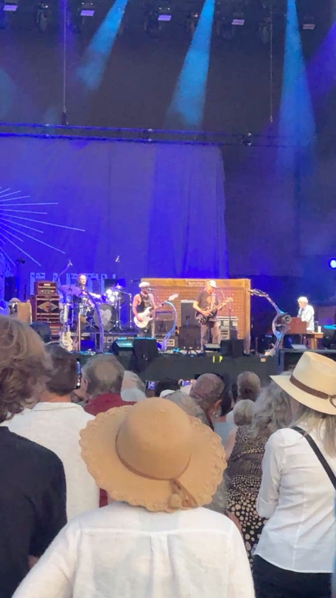 The band on stage, all wielding their instruments,with Neil Young second from the right.