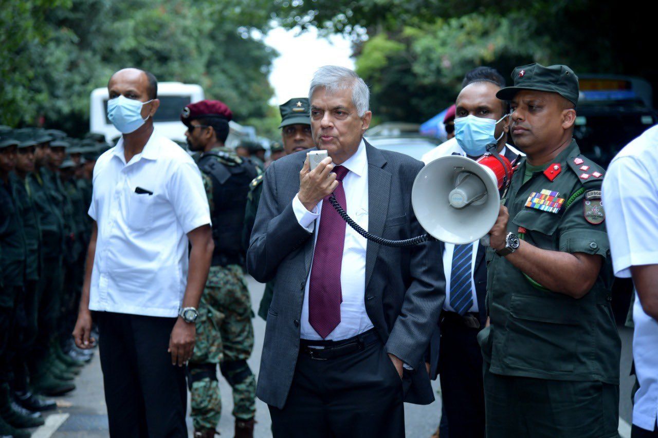 A photo of the Sri Lankan president, Ranil Wickremesinghe, addressing the military with a megaphone