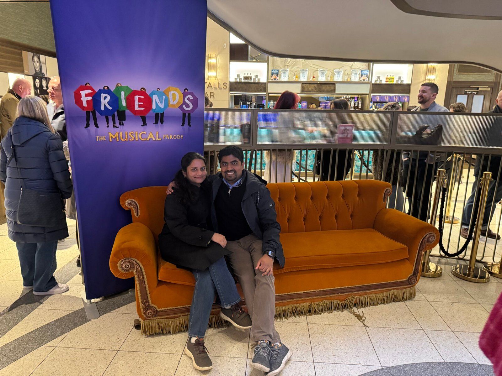 Nuwani and I sitting on the Central Perk couch that was set up on the foyer of the theatre