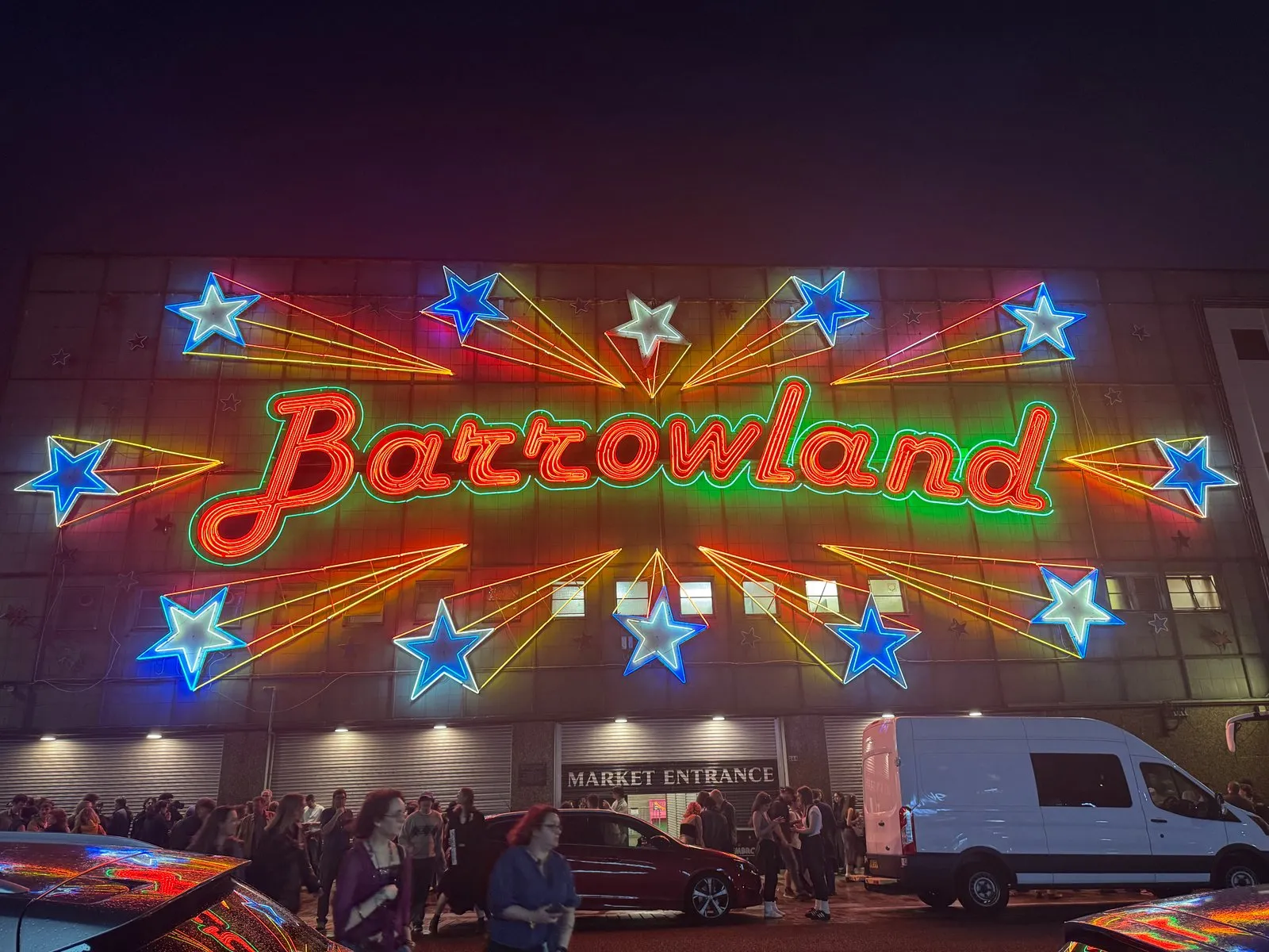 The multi-coloured neon signage on the front face of the Barrowland building beautifully illuminated at night