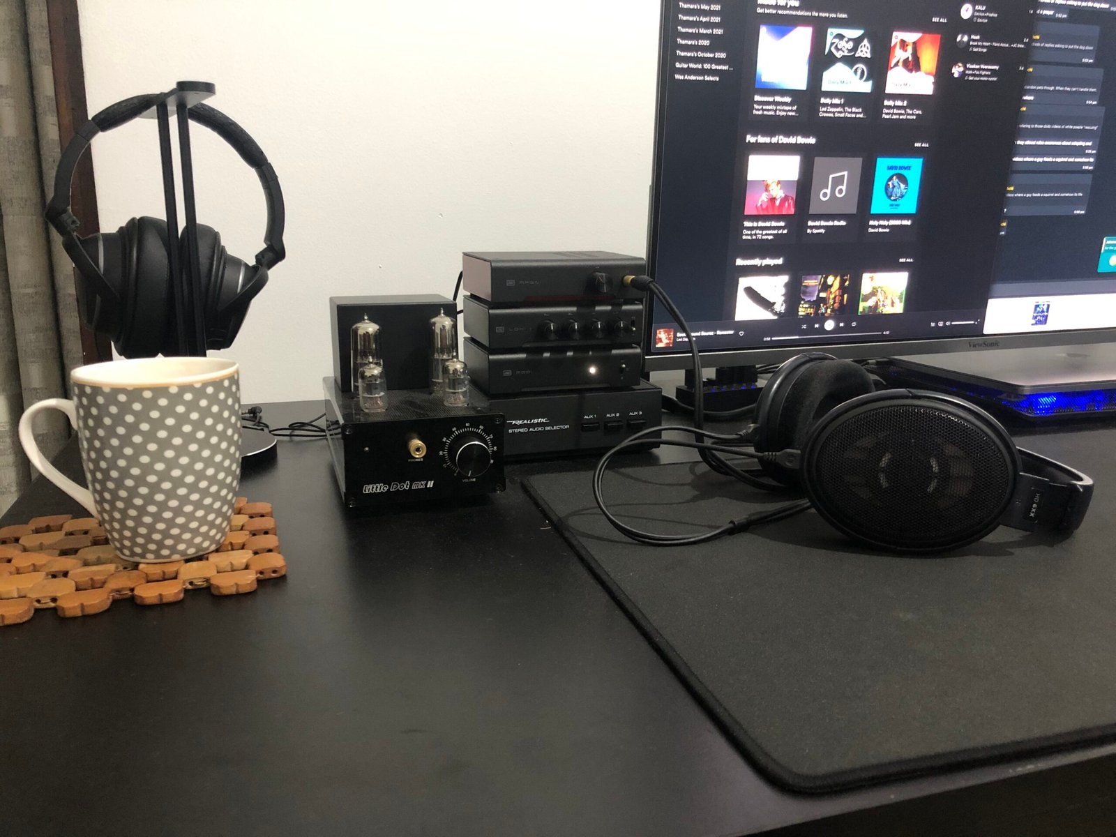 Headphone setup featuring a stack of contollers (amp, DAC, equaliser and switcher)