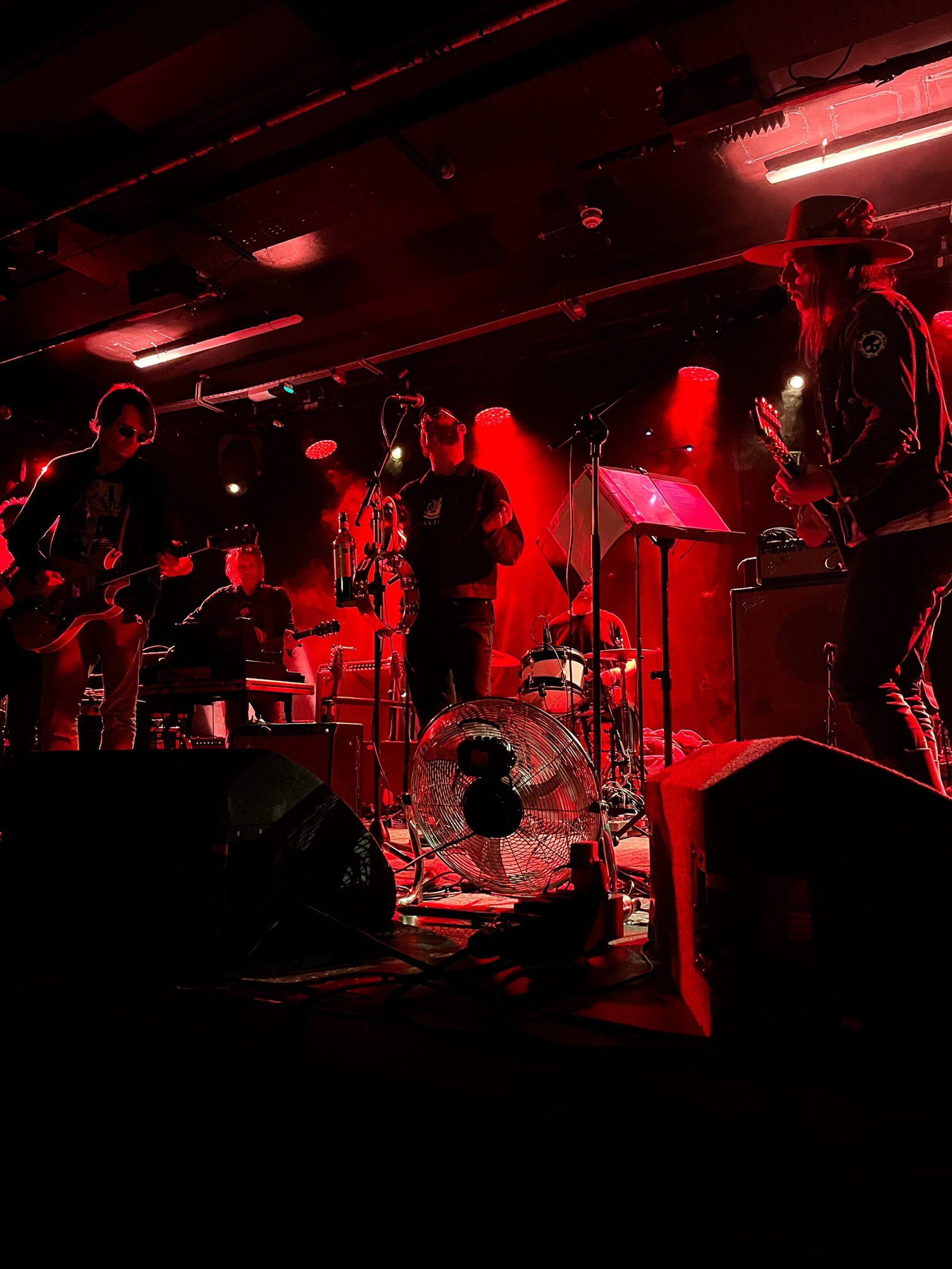 The band on stage, awash in red light, at the Limelight.