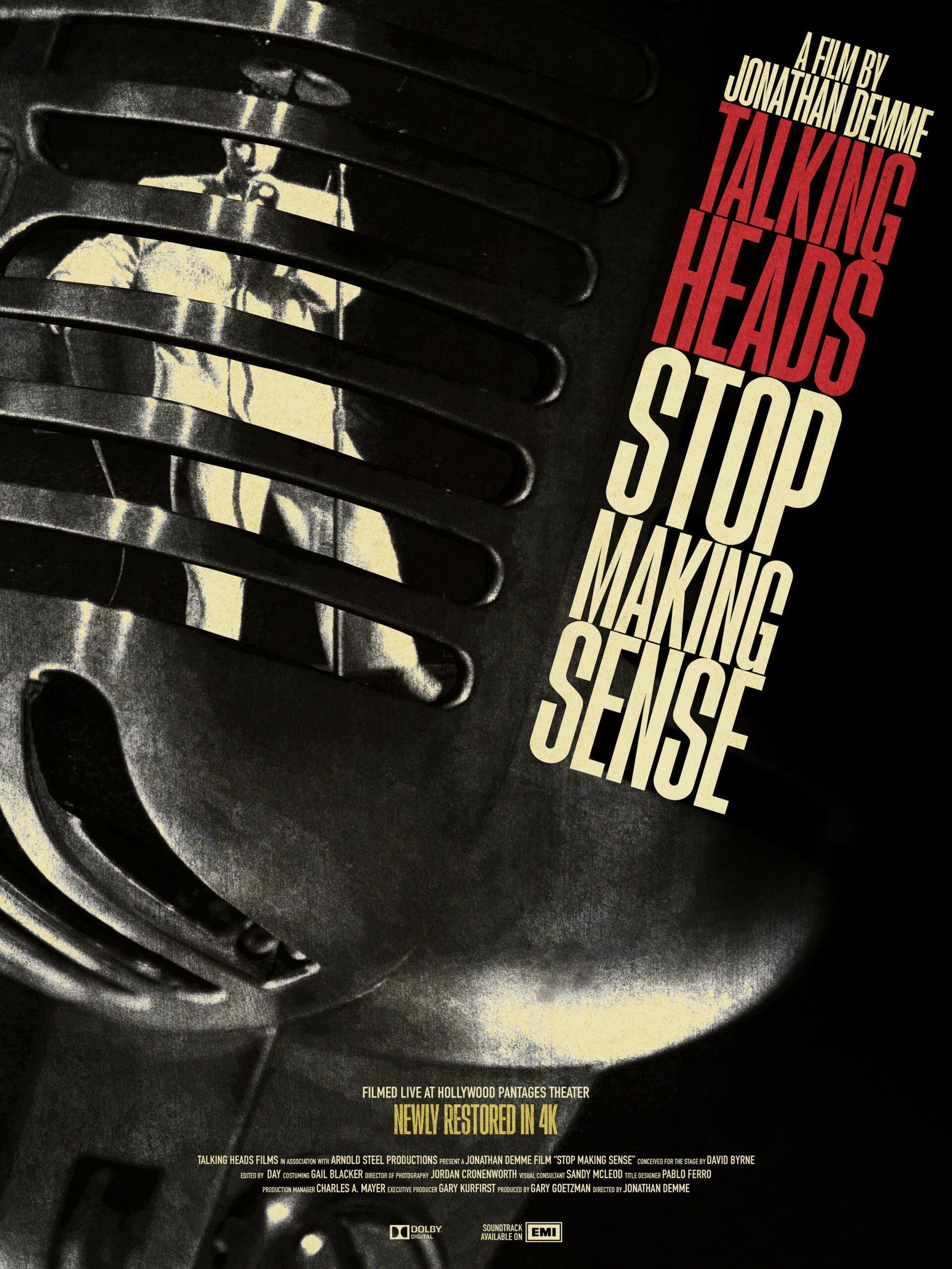 A large microphone, through which a dancing David Byrne can be seen. The film title is off to the right hand side of the microphone.