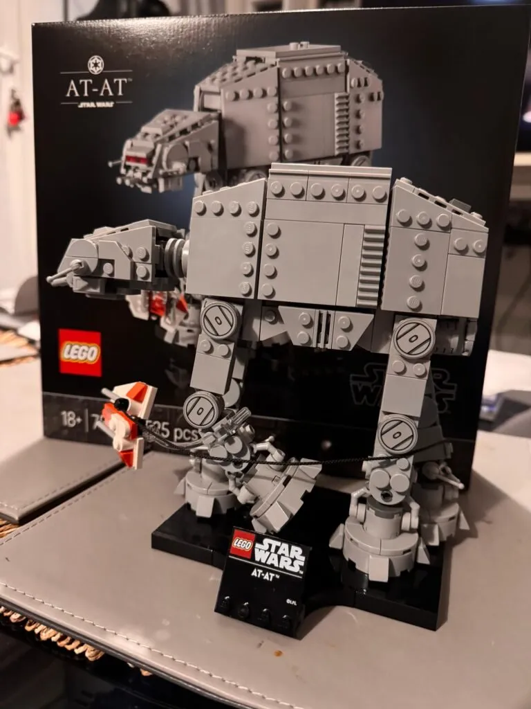 The AT-AT Lego build, posed in front of its box