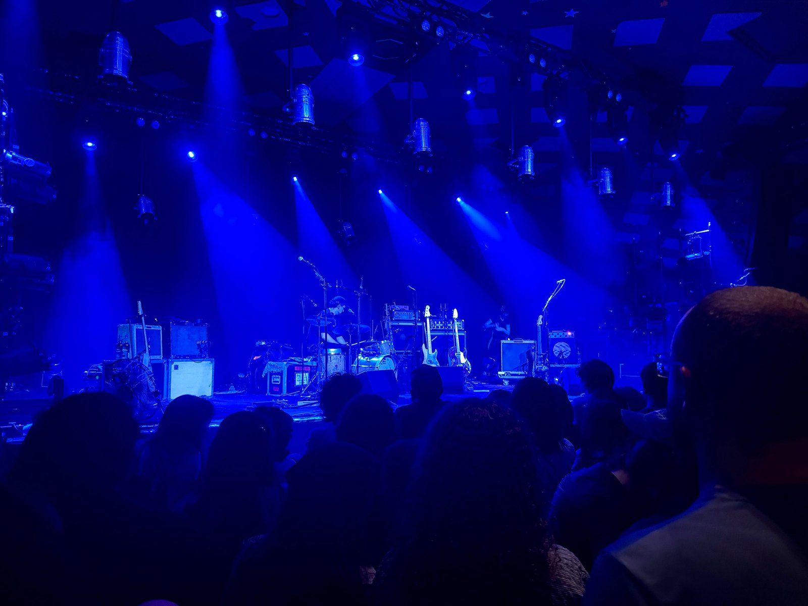 The stage at Barrowland, awash in blue light, as Big Thief's crew get their instruments ready before the gig