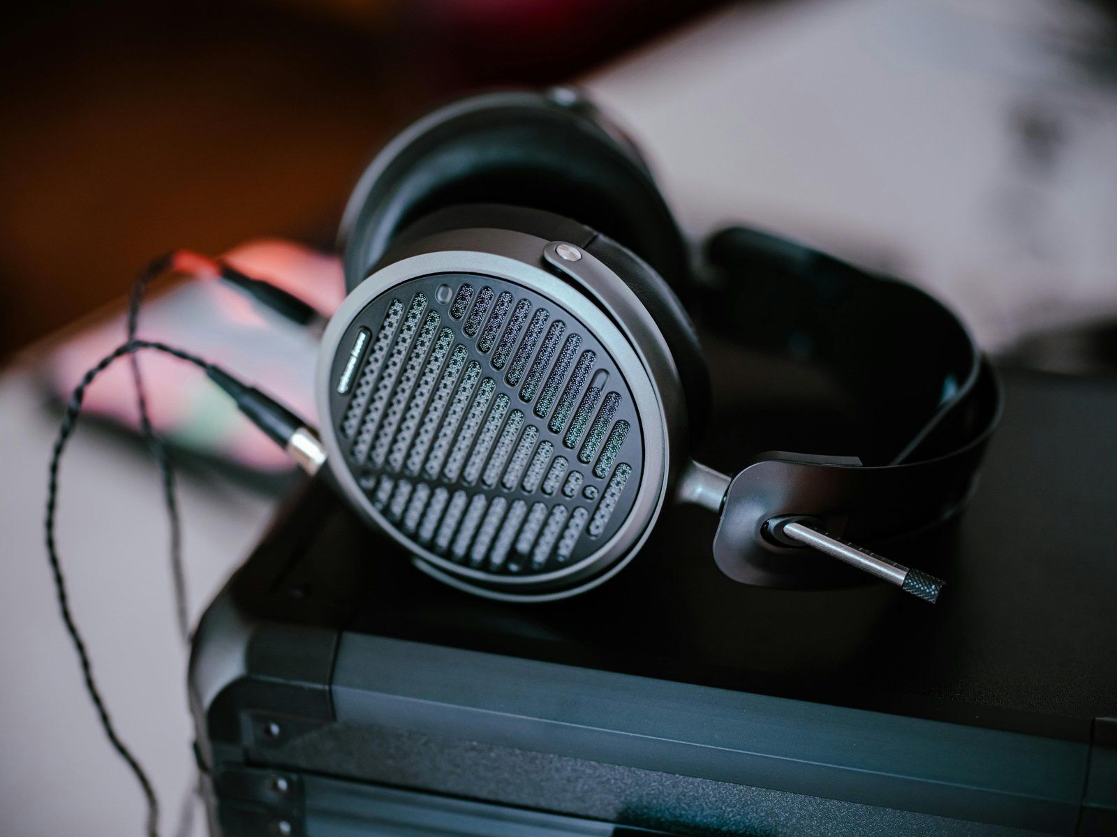 Close-up of professional headphones on a desk, featuring intricate design and modern audio technology.