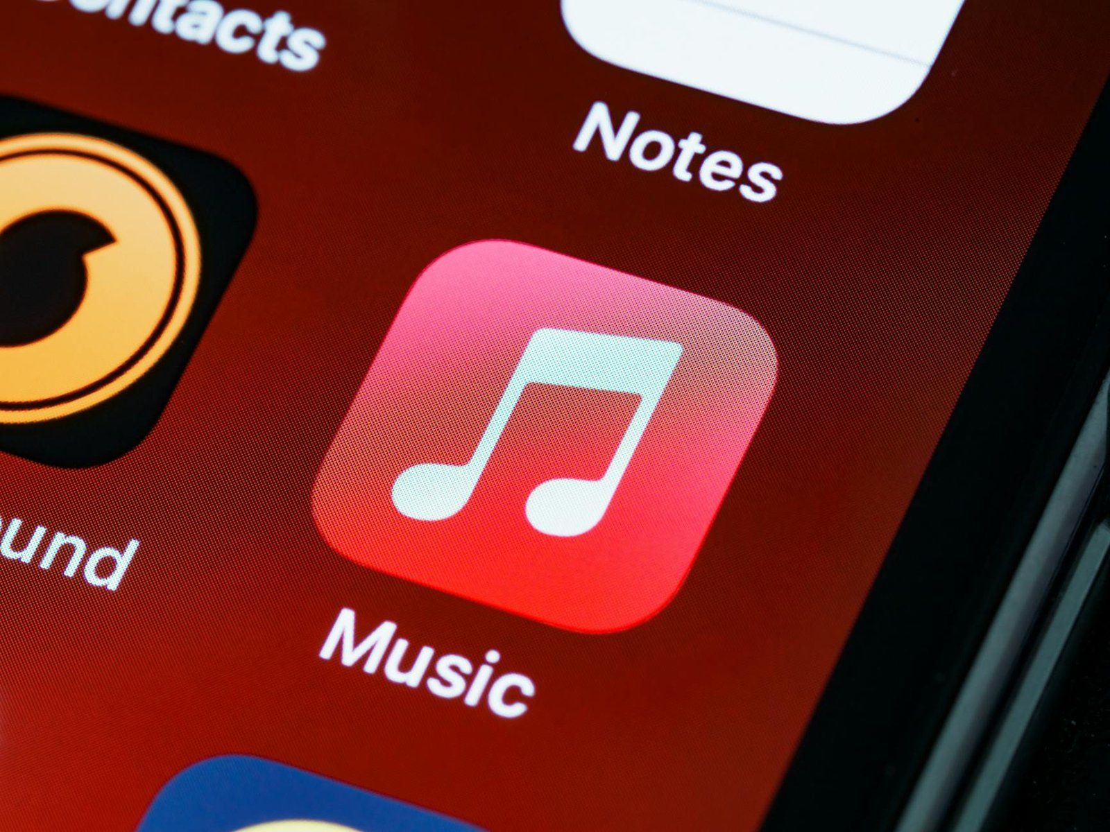 Detailed close-up of an iPhone home screen featuring the music app icon