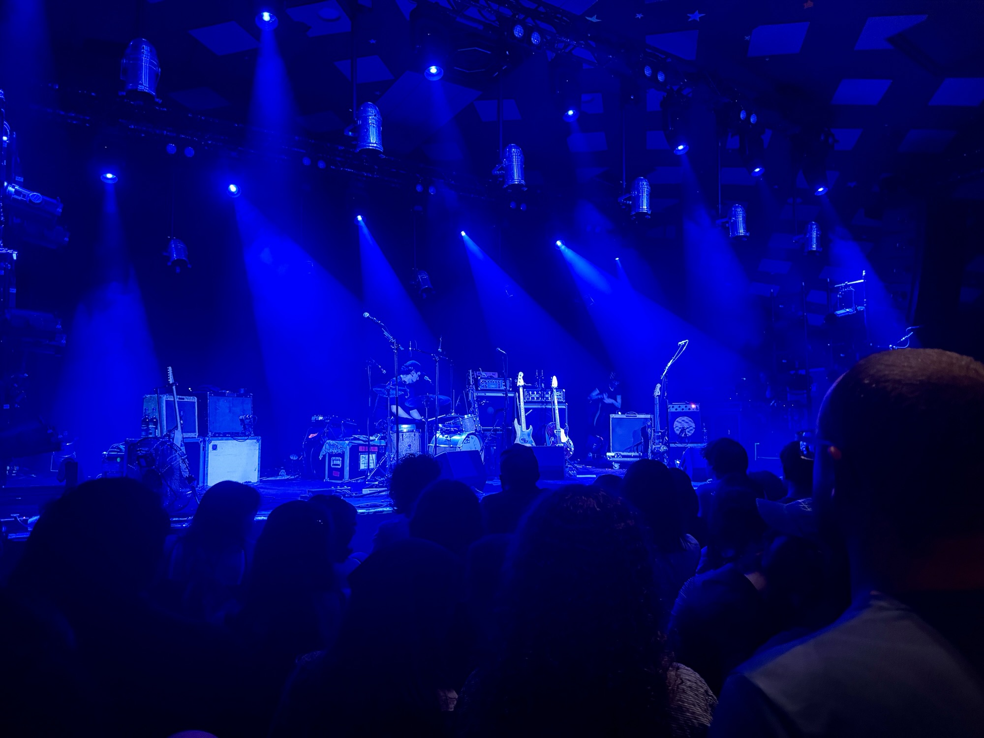The stage at Barrowland, awash in blue light, as Big Thief's crew get their instruments ready before the gig